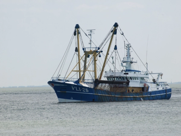 Trawler boat at sea near a lighthouse